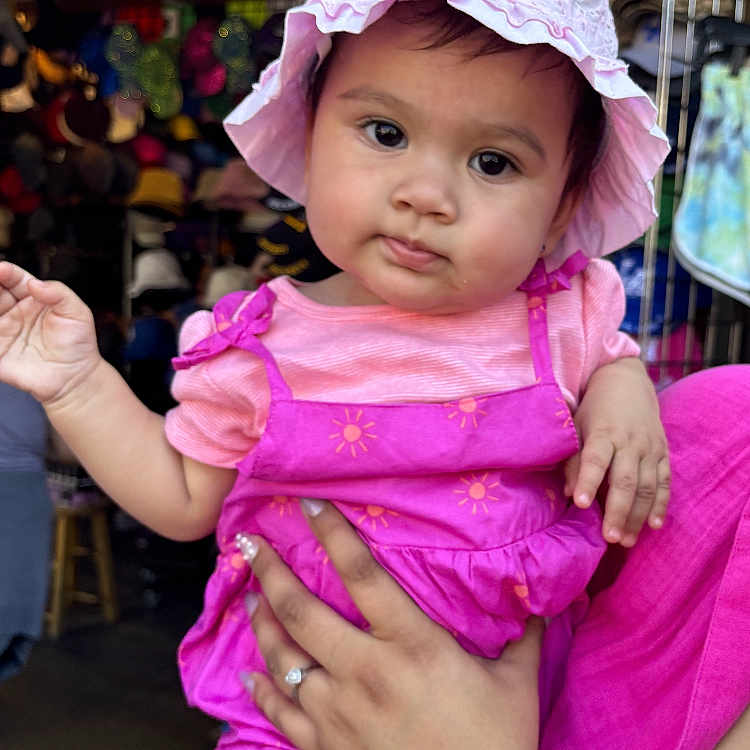 Leilani joined the competition — help win amazing prizes! baby, bodypart, bonnet, cap, clothing, diaper, dress, face, festival, finger, hand, hanukkahmenorah, hat, head, person, sunhat