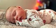 Willow joined the competition — help win amazing prizes! baby, blanket, blurred_background, child, closeup, comfort, cozy, cute, face, holiday_theme, indoors, infant, pajamas, peaceful, portrait, rest, skin, sleeping, soft_texture, warm_light