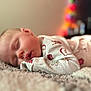 Willow joined the competition — help win amazing prizes! baby, sleeping, pajamas, blanket, face, child, infant, soft_texture, cozy, closeup, peaceful, indoors, portrait, cute, rest, warm_light, blurred_background, holiday_theme, comfort, skin