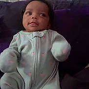 Nayloni joined the competition — help win amazing prizes! baby, infant, onesie, pink, pastel, cushion, purple, face, hands, cozy, indoor, child, cute, small, portrait, relaxing, looking_away, soft_lighting, young, seated