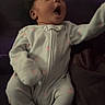 Nayloni joined the competition — help win amazing prizes! baby, infant, pajamas, cute, surprised, expression, face, child, person, footed_pajamas, cozy, indoors, soft_lighting, dark_background, lying_down, newborn, sleepwear, small, adorable, curious
