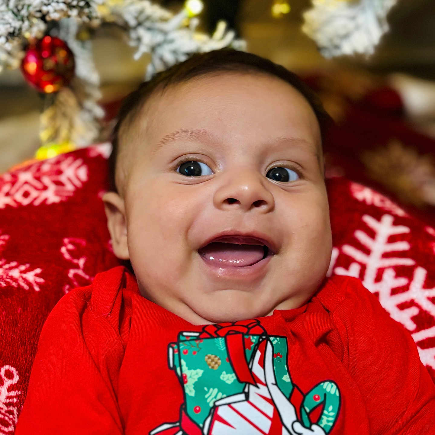 Sebasthian joined the competition — help win amazing prizes! baby, blanket, celebration, child, christmas_lights, christmas_tree, cute, face, festive, happy, holiday, indoors, infant, joyful, nike, ornament, portrait, red_shirt, seasonal, smiling