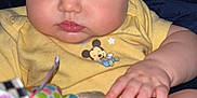 Eliza joined the competition — help win amazing prizes! baby, child, infant, face, hand, foot, yellow_shirt, mickey_mouse, polka_dot, colorful_toy, soft_toy, indoor, closeup, cute, wet_hair, skin, expression, person, playing, focus