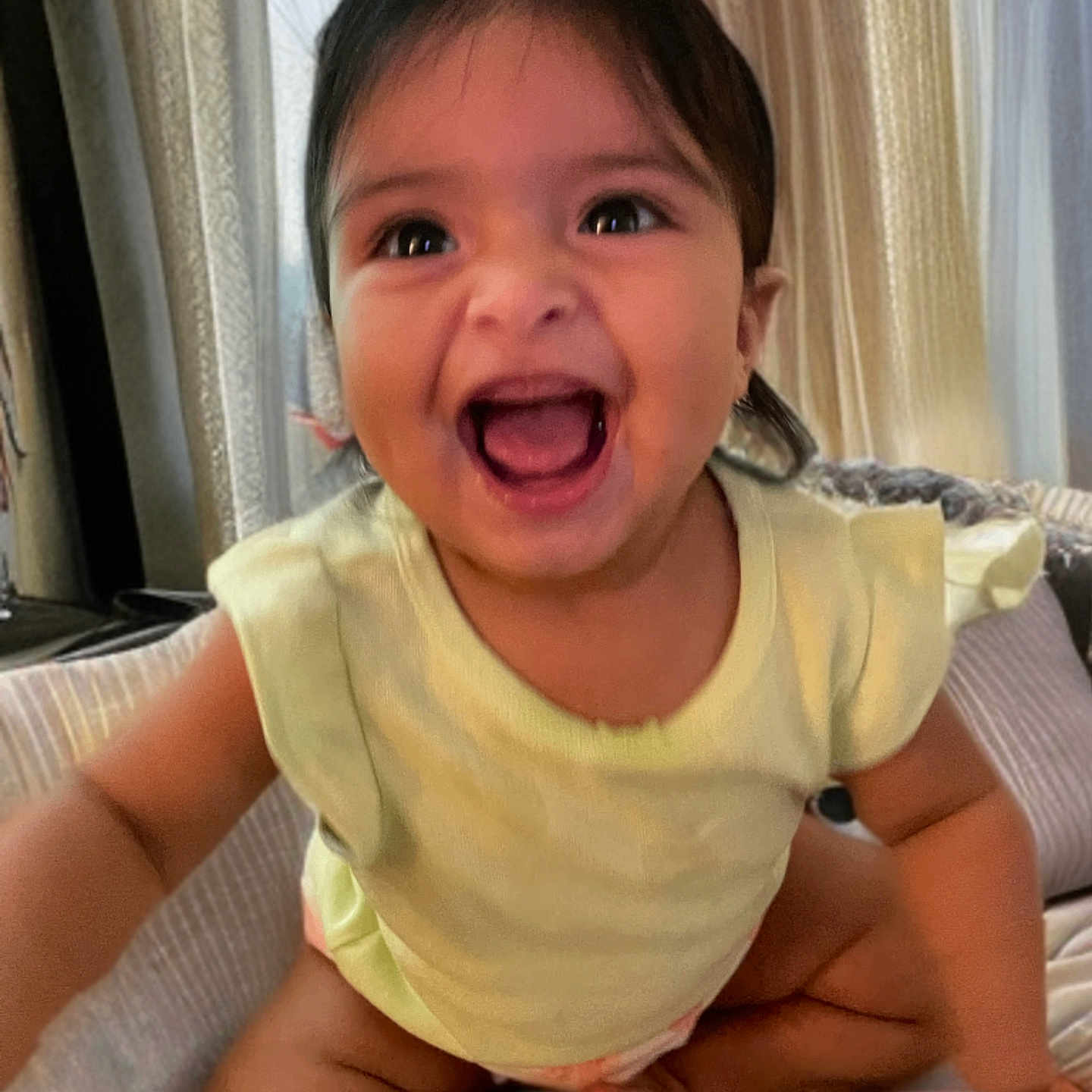 Emerie is registered to the contest to win money with this photo: baby, babylaughing, bodypart, clothing, couch, face, finger, furniture, hand, happy, head, homedecor, laughing, mouth, person, photography, portrait, sitting, smile, teeth