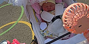 Destini-Grace joined the competition — help win amazing prizes! baby, stroller, hand, lace, canopy, outdoor, sunlight, toy, fan, energy_drink, drink_can, pavement, child, sleeping, person, clothing, pink, white, playground, accessory