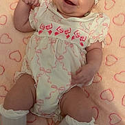 Destini-Grace is registered to the contest to win money with this photo: baby, infant, smiling, headband, bow, blanket, hearts, pink, white_clothing, socks, cute, happy, lying_down, soft_texture, face, child, closeup, adorable, indoors, portrait