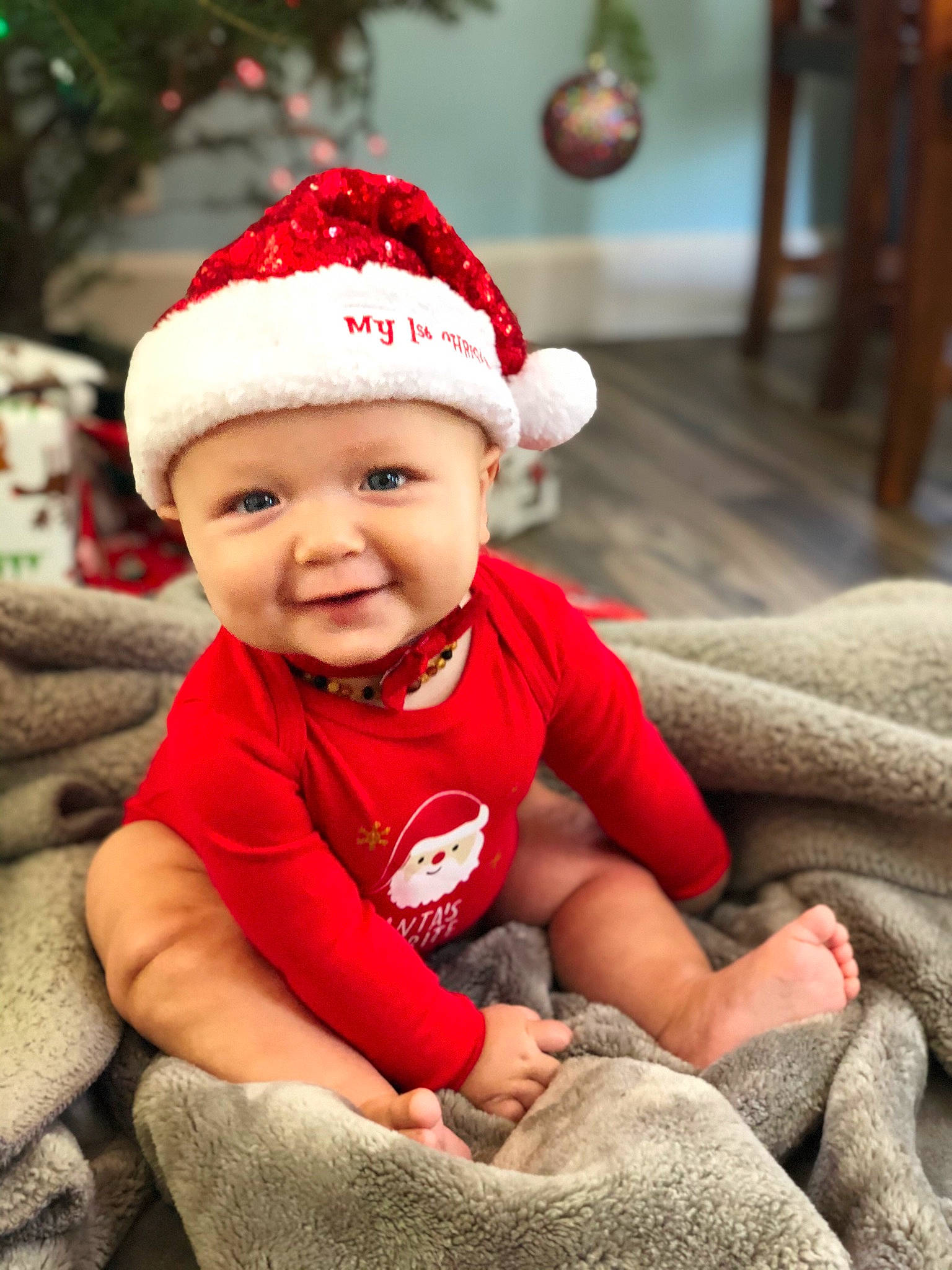 Judah is registered to the contest to win money with this photo: baby, baby_toddler_clothing, cap, cheek, comfort, facial_expression, fun, green, happy, hat, head, headwear, joy, lip, mammal, person, red, skin, sleeve, smile