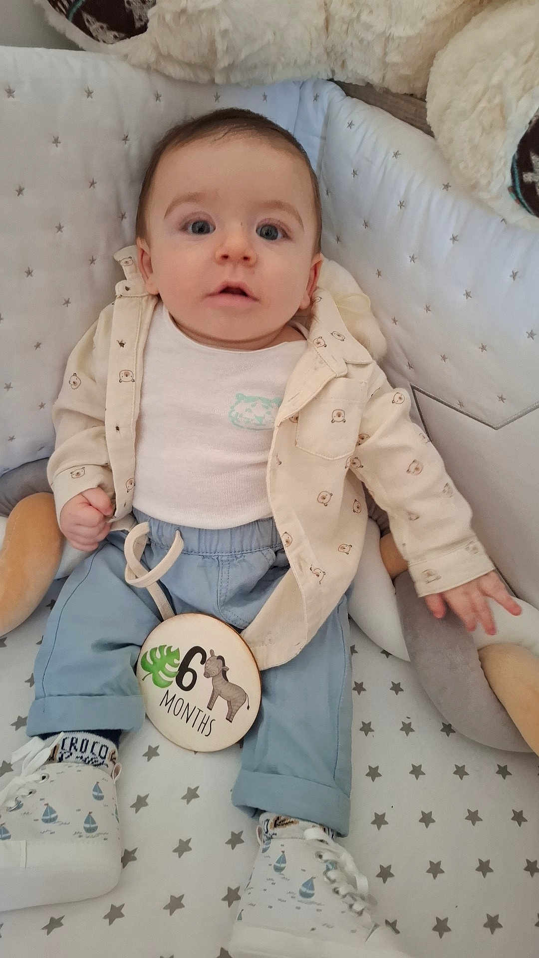 Tylio participe au concours pour gagner de l'argent avec cette photo : baby, infant, crib, milestone, clothing, shirt, pants, sneakers, socks, toy, star_pattern, face, eyes, hand, footwear, cute, indoor, portrait, child, 6_months