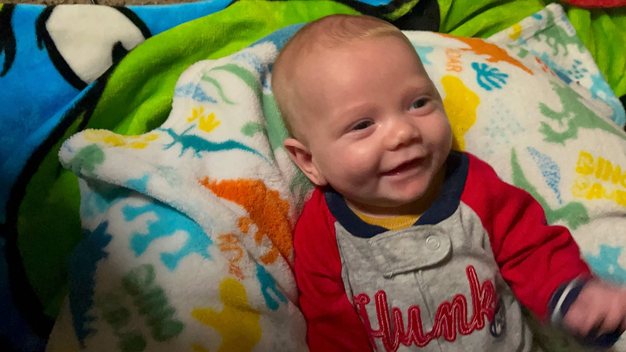 Leland is registered to the contest to win money with this photo: baby, baby_toddler_clothing, cheek, child, chin, eye, eyebrow, happy, iris, jacket, joy, mammal, mouth, nose, person, product, skin, sleeve, smile, t_shirt