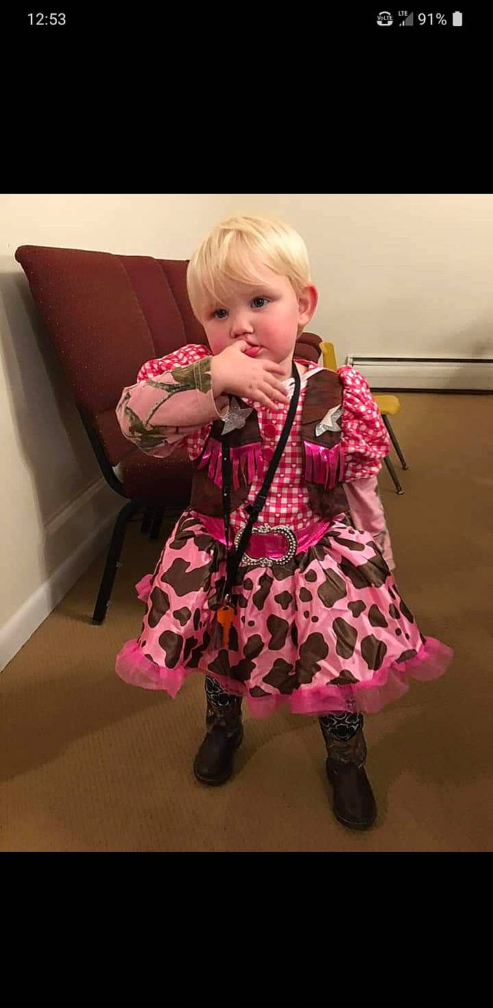 Aubrey is registered to the contest to win money with this photo: clothing, day_dress, doll, dress, fashion_design, fawn, flooring, human_leg, knee, magenta, one_piece_garment, pattern, person, pink, purple, shoe, sleeve, thigh, toy, waist