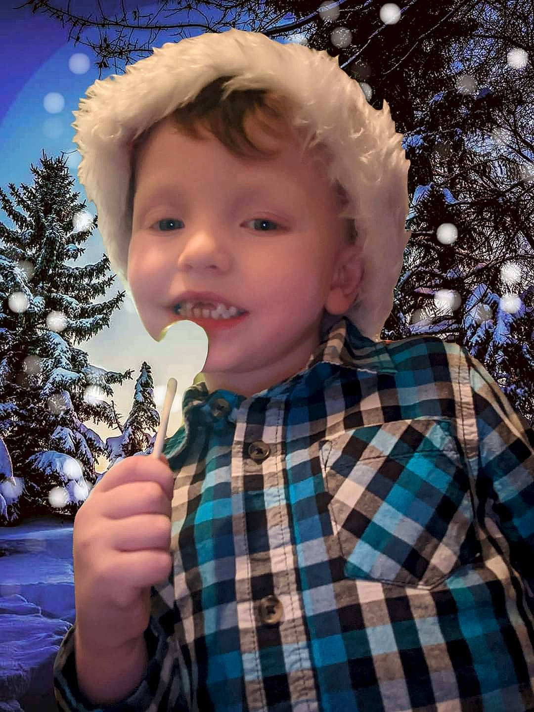Michael is registered to the contest to win money with this photo: child, chin, christmas_tree, dress_shirt, electric_blue, event, facial_expression, fun, gesture, happy, pattern, people, people_in_nature, person, plaid, sleeve, snow, standing, tartan, toddler