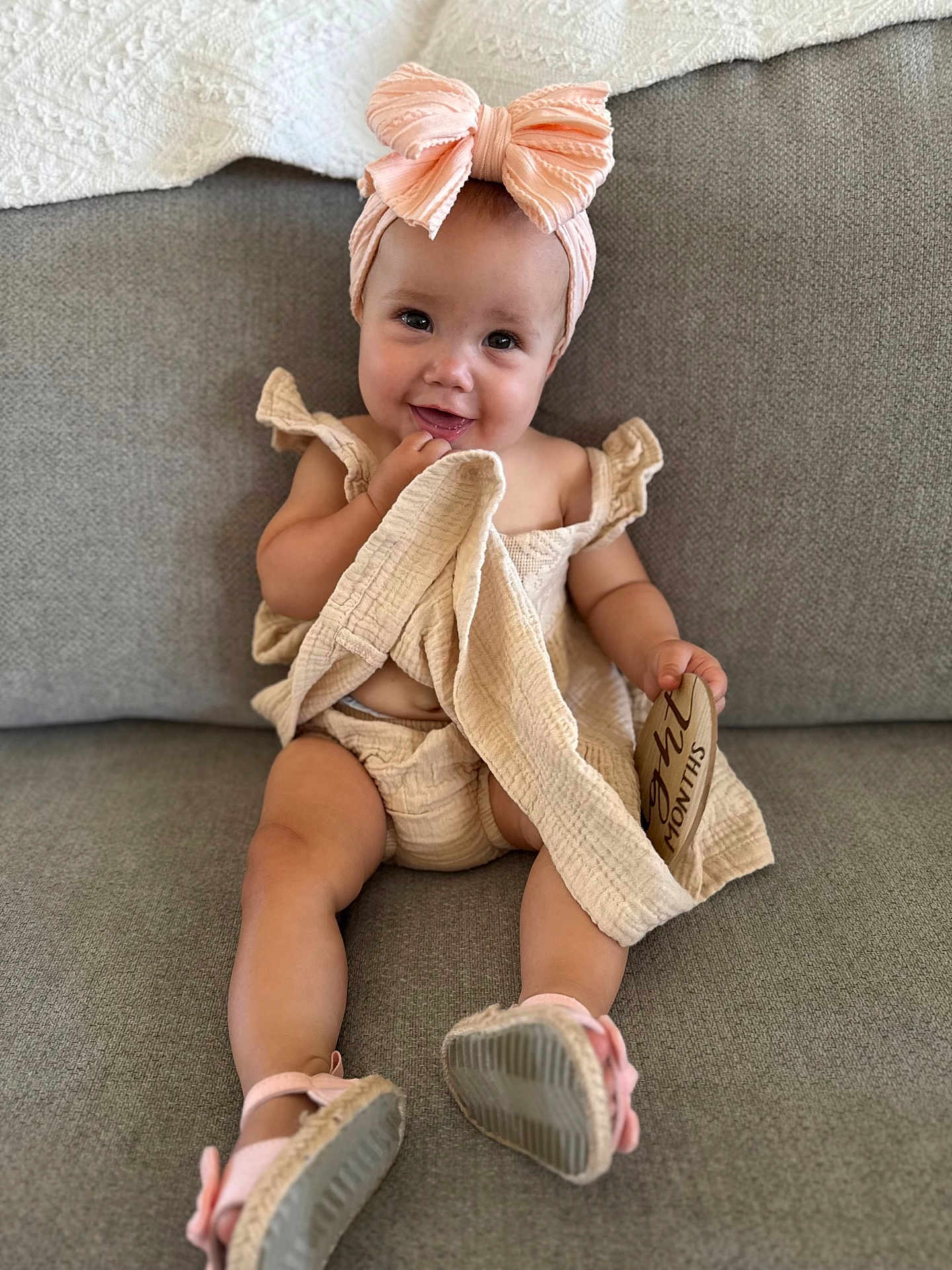 Avery joined the competition — help win amazing prizes! baby, child, smiling, sitting, indoor, headband, bow, cute, clothing, footwear, shoes, couch, fabric, skin, person, portrait, happy, infant, wooden_sign, home