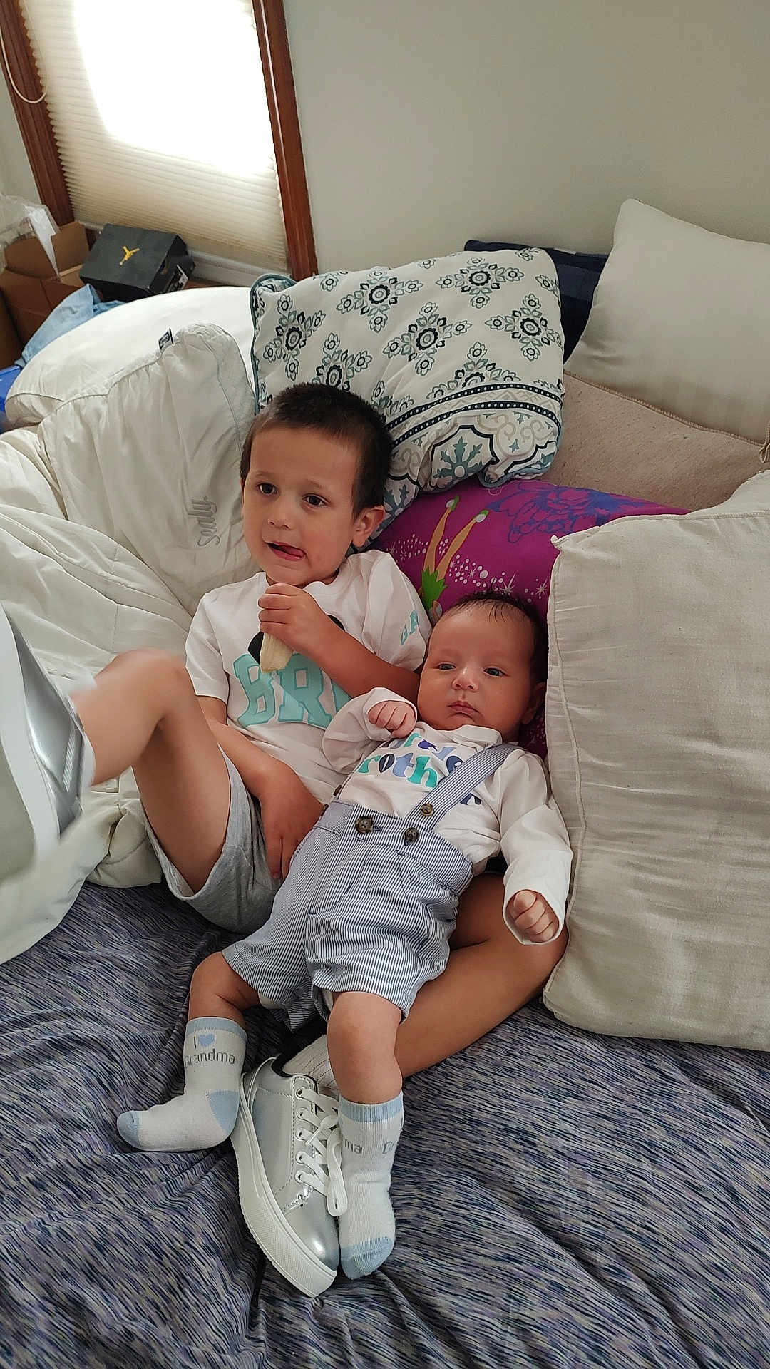 Enzo joined the competition — help win amazing prizes! child, baby, couch, pillow, socks, shoes, clothing, indoor, family, snack, baby_clothes, casual, relaxing, portrait, two_children, cute, comfortable, home, infant, toddler