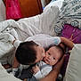 Enzo joined the competition — help win amazing prizes! baby, child, cuddle, kiss, bed, blanket, pillow, indoor, family, love, affection, person, clothing, young, cute, comfort, home, sleepwear, rest, tenderness