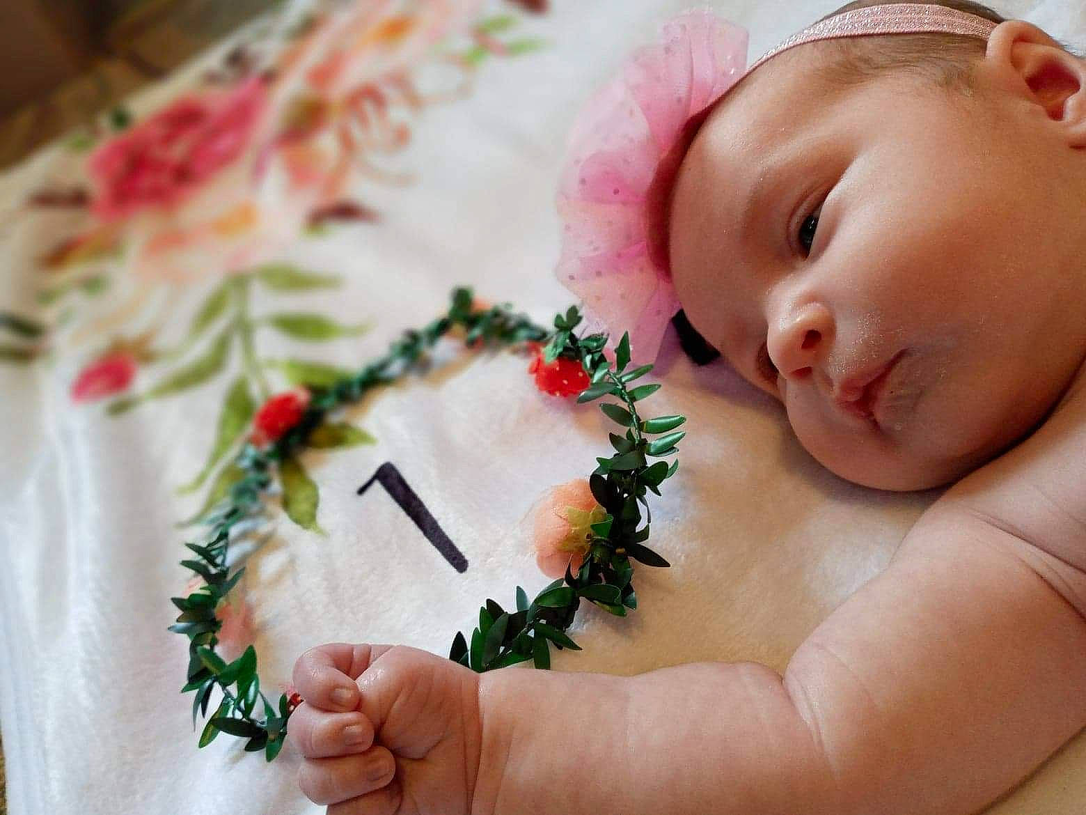 Izzy joined the competition — help win amazing prizes! baby, baby_toddler_clothing, bouquet, child, cut_flowers, dress, event, finger, flower_arranging, gesture, grass, hand, happy, nail, pattern, person, petal, plant, skin, thumb