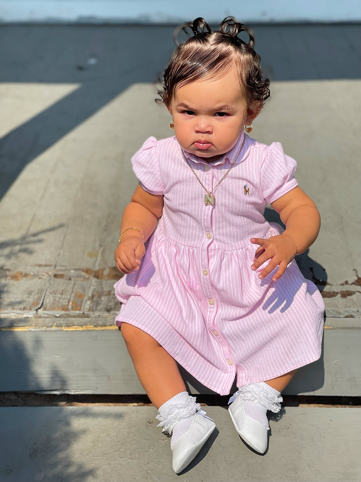 Nylah is registered to the contest to win money with this photo: baby_toddler_clothing, child, day_dress, fashion_accessory, foot, fun, happy, human_leg, knee, magenta, one_piece_garment, pattern, person, pink, purple, sandal, sitting, sleeve, sock, street_fashion