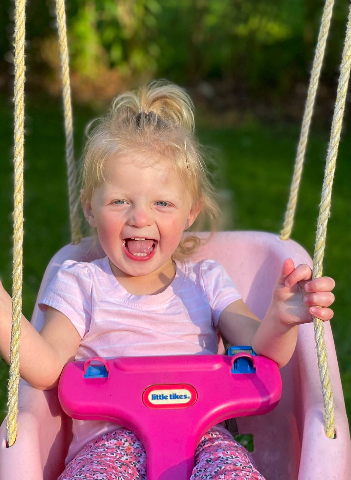 Jenna is registered to the contest to win money with this photo: arm, eye, face, facial_expression, finger, grass, hand, happy, head, human_body, nature, people_in_nature, person, photograph, pink, playground, product, skin, smile, standing