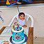 Elyes a rejoint le concours — aidez-le/la à gagner de superbes lots ! toddler, child, birthday_cake, paw_patrol, balloons, chair, table, outdoor, celebration, smiling, plastic_chair, blue_cake, cake_toppers, first_birthday, party, decorations, window, wooden_table, happy, person