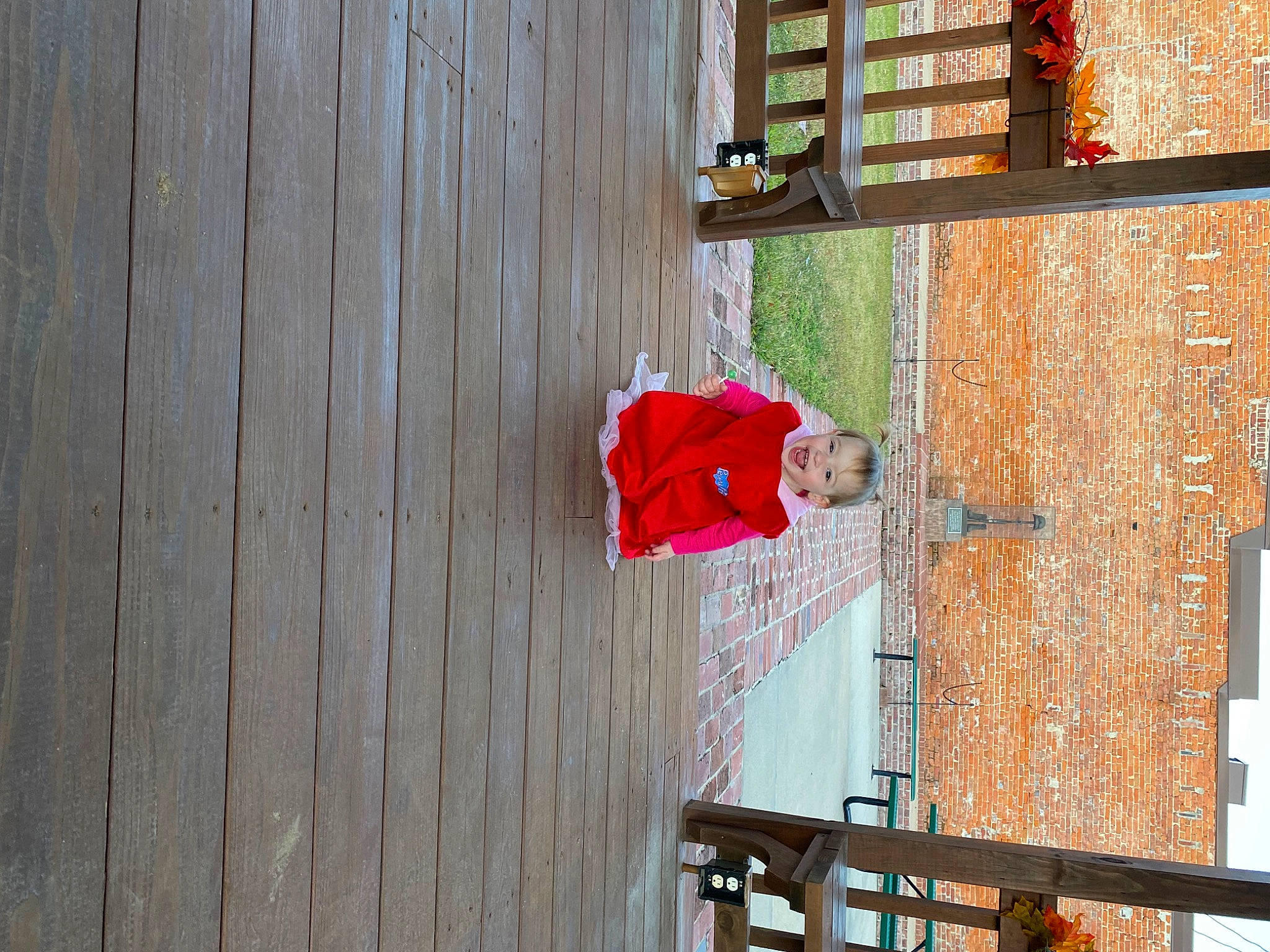 Oaklee is registered to the contest to win money with this photo: balcony, brick, building, carmine, facade, flooring, flowerpot, handrail, hardwood, house, houseplant, magenta, pattern, person, plant, property, room, tree, window, wood