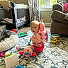baby, child, toy, backpack, snail, carpet, living_room, window, curtains, sofa, floor, play, indoor, person, colorful, cushion, baby_bed, plush_toy, child_sitting, daylight