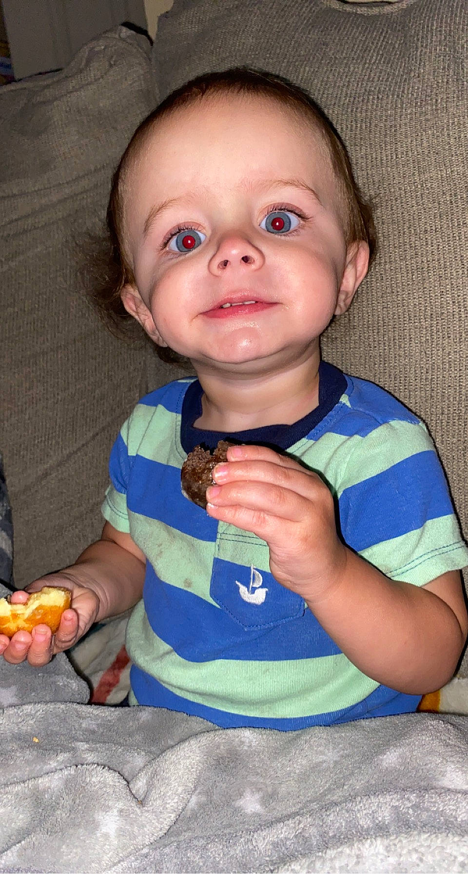 Blake is registered to the contest to win money with this photo: baby, baby_toddler_clothing, cheek, child, electric_blue, eyelash, finger, fun, gesture, hand, happy, nail, natural_foods, nose, person, produce, sitting, sleeve, t_shirt, thumb