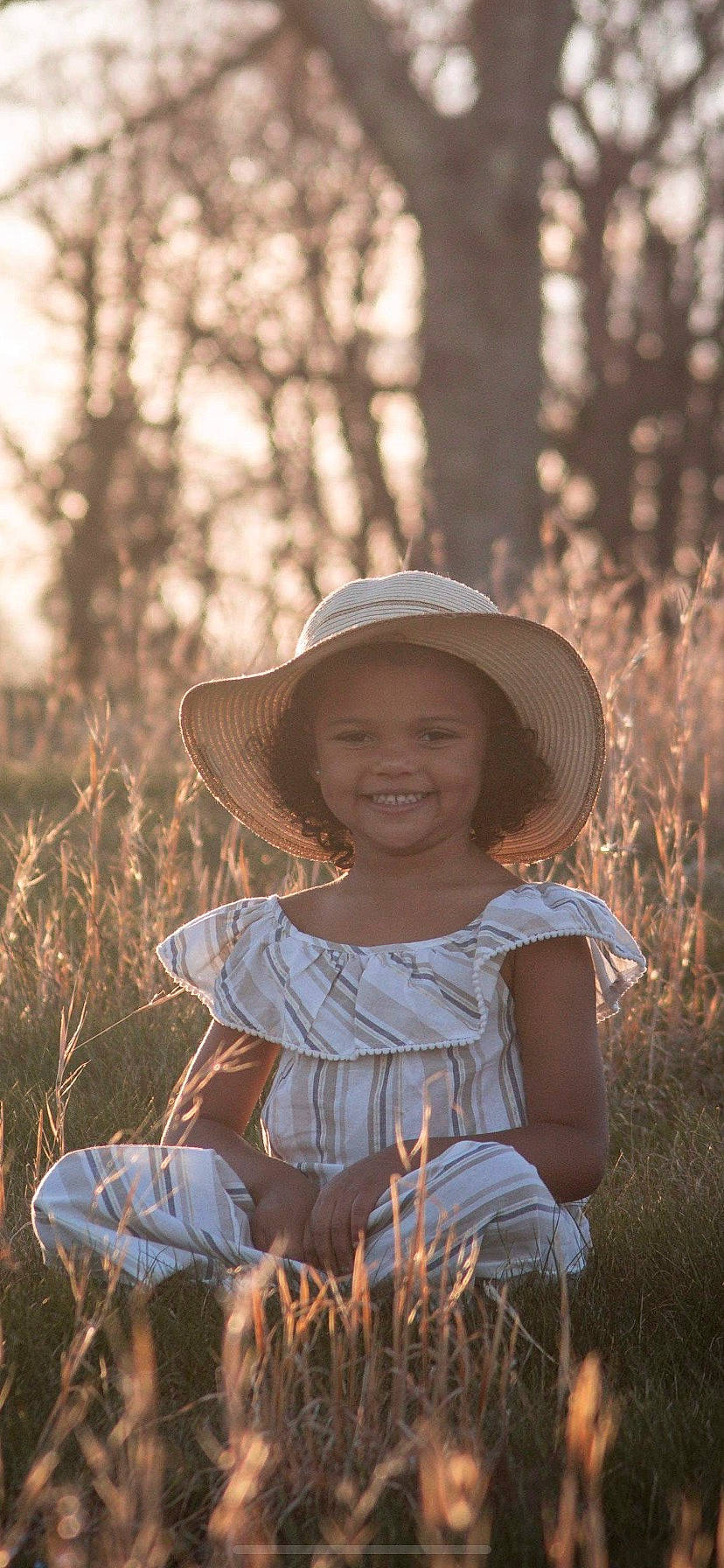 Ja Ariess is registered to the contest to win money with this photo: beauty, eye, face, flash_photography, grass, grassland, happy, hat, headgear, joy, landscape, meadow, people, people_in_nature, person, plant, smile, sun_hat, sunlight, toddler