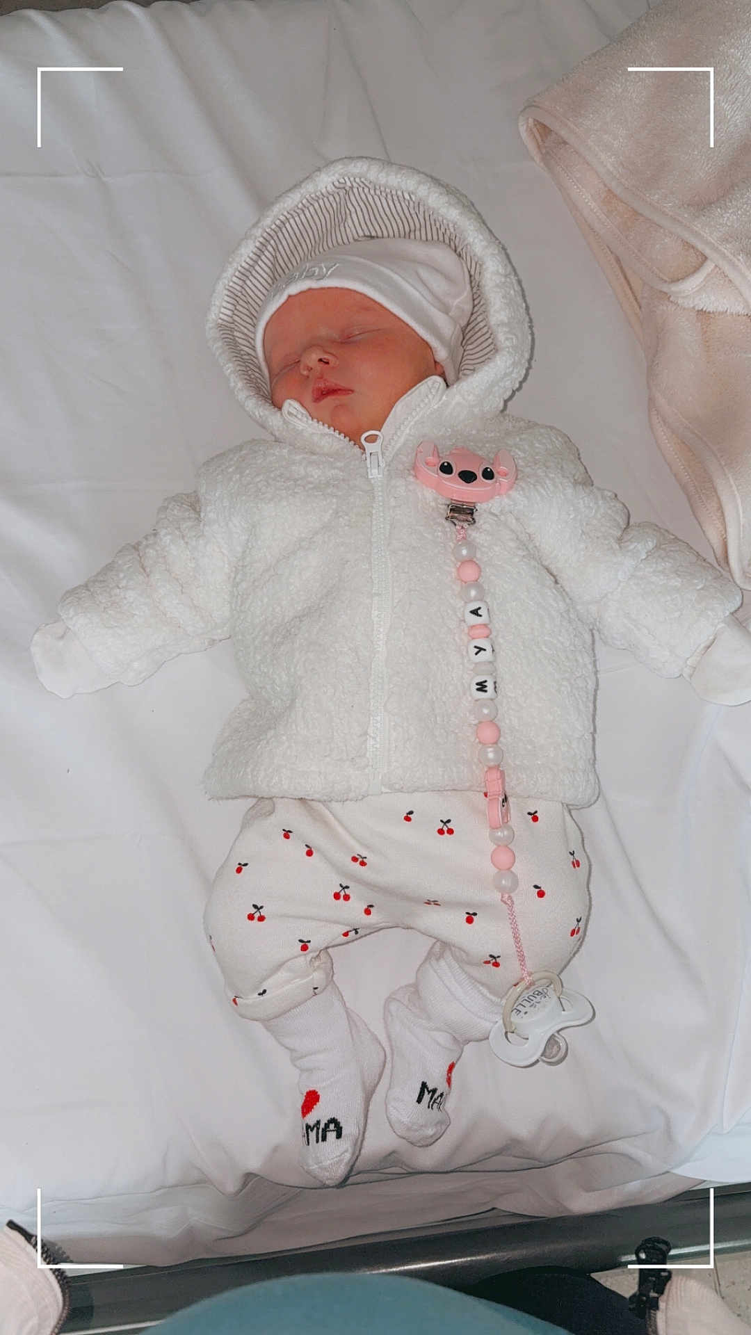 Mya participe au concours pour gagner de l'argent avec cette photo : baby, sleeping, white_jacket, hood, pacifier, pacifier_clip, cherry_pattern, pants, socks, bed, blanket, cute, infant, child, newborn, clothing, indoor, resting, adorable, soft