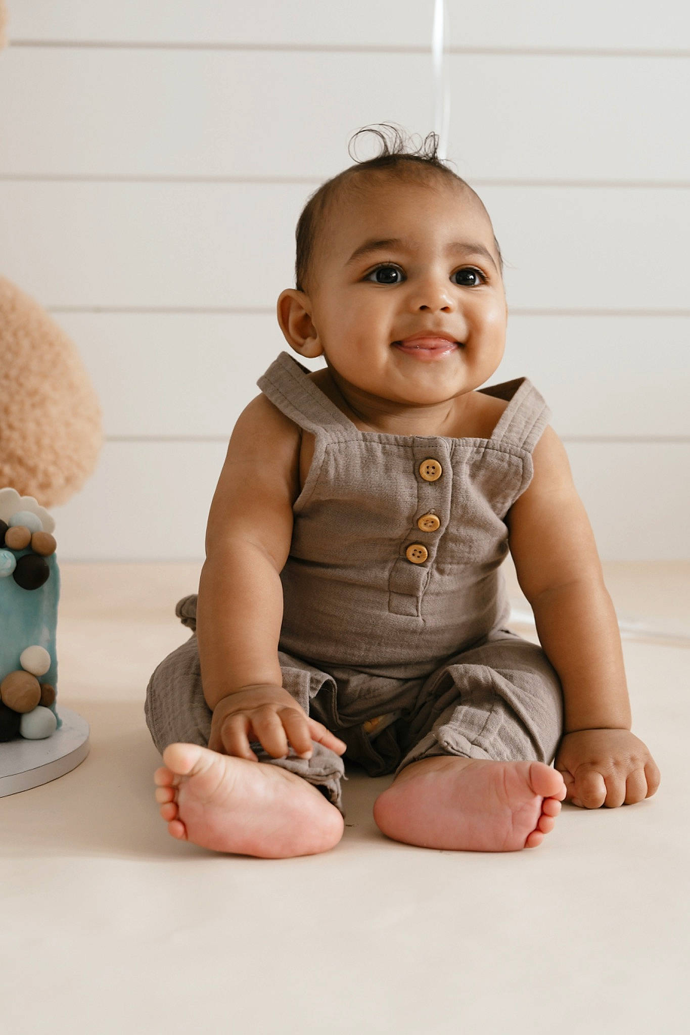 David Jaymes is registered to the contest to win money with this photo: baby, baby_toddler_clothing, barefoot, cheek, child, chin, eye, finger, flash_photography, flooring, foot, gesture, happy, human_leg, joy, person, skin, sleeve, smile, thumb