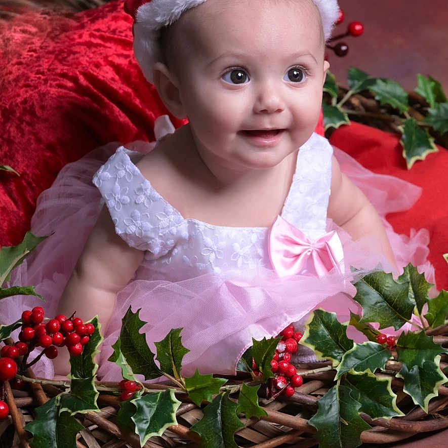 Aria is registered to the contest to win money with this photo: baby, bonnet, clothing, cream, dessert, face, flower, flowerarrangement, flowerbouquet, food, happy, hat, head, leaf, person, photography, plant, portrait, rose, smile