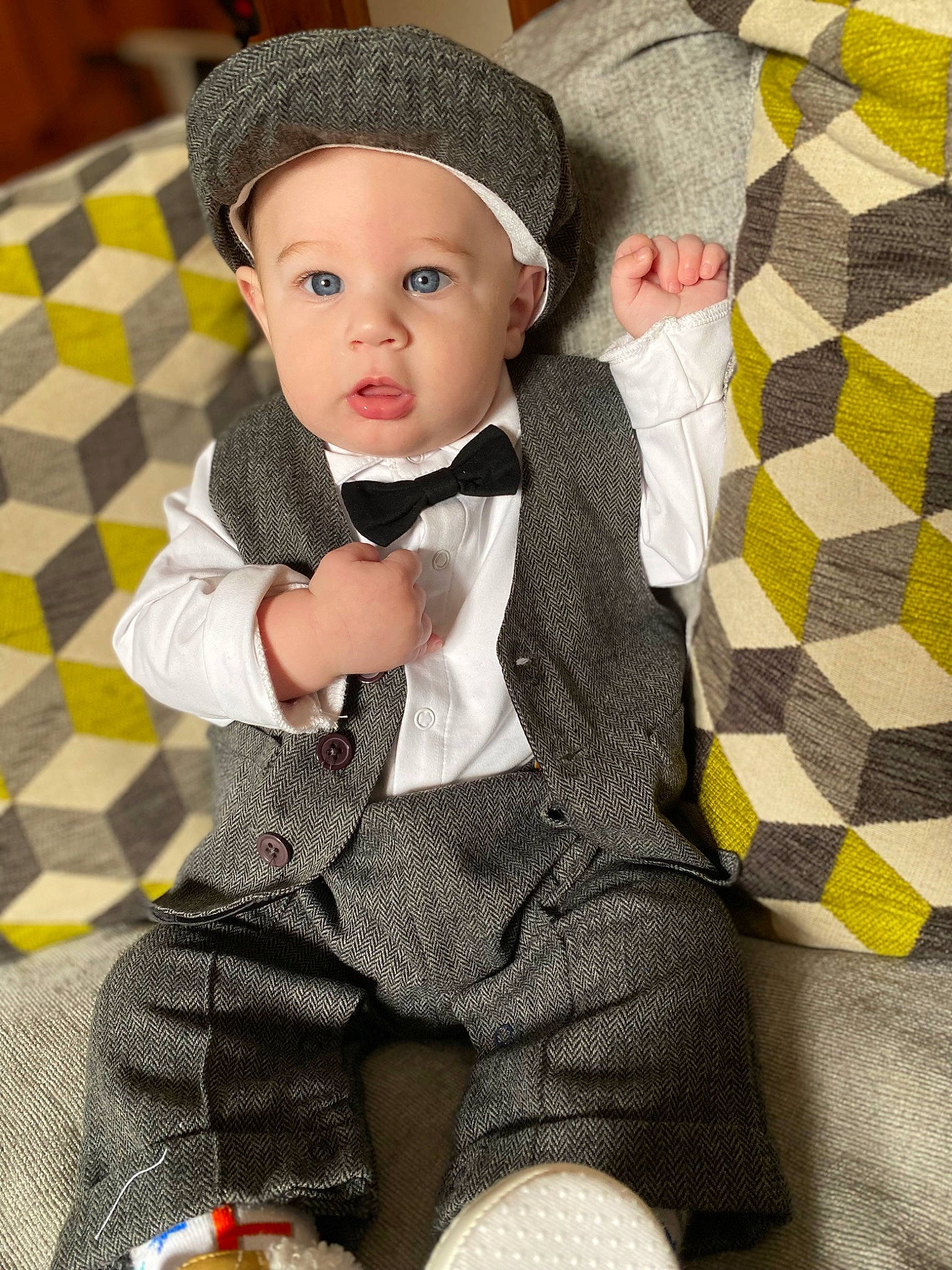 Franklin is registered to the contest to win money with this photo: baby, baby_toddler_clothing, blazer, bow_tie, cap, child, collar, costume_hat, doll, flooring, formal_wear, hat, headgear, headwear, linens, pattern, person, sleeve, suit, tie