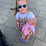 child, girl, sunglasses, doll, toy, pavement, outdoor, dress, footwear, plastic_doll, hair_tied, summer_clothing, person, cute, play, standing, daylight, casual, fun, happy