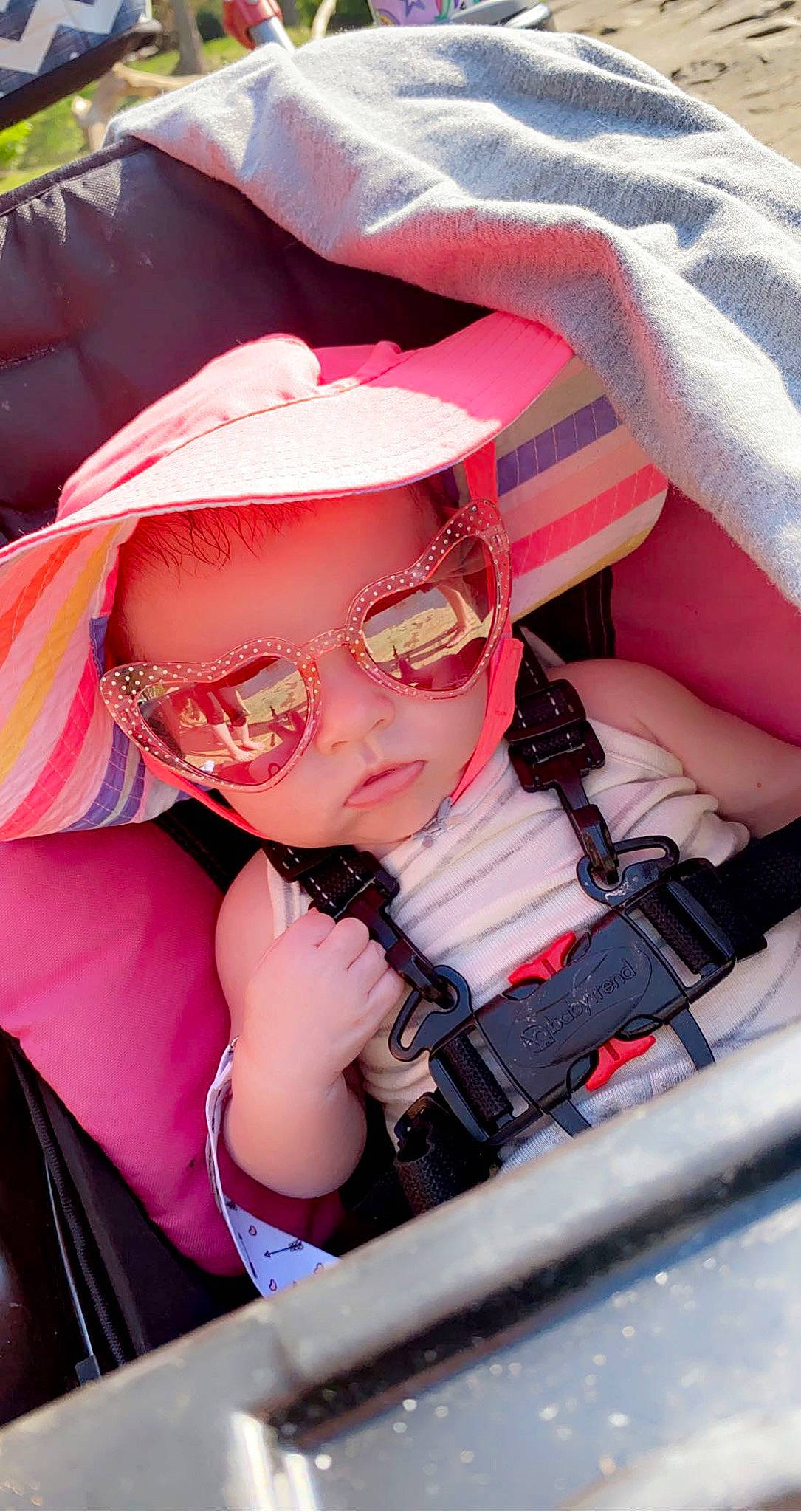 Nalani is registered to the contest to win money with this photo: baby_carriage, carmine, child, cool, eyewear, fashion_accessory, fun, goggles, happy, leisure, magenta, outdoor_recreation, pattern, person, personal_protective_equipment, pink, purple, recreation, sun_hat, toddler