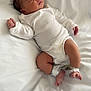 newborn, baby, sleeping, white_clothing, hospital_band, blanket, infant, peaceful, lying_down, soft_light, indoors, human, skin, legs, arms, face, head, resting, cute, toddler