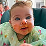 baby, blue_eyes, messy_face, food, bib, high_chair, kitchen, indoor, child, person, cute, face, smiling, clothing, watermelon_pattern, mess, feeding, happy, young_child, portrait
