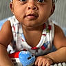 baby, child, closeup, clothing, colorful, curious, cute, expression, face, hand, headband, indoor, infant, lying_down, plush_toy, portrait, skin, soft_texture, toy_airplane, young