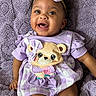 apparel, baby, bear_applique, blanket, cheerful, child, clothing, cute, face, happy, headband, indoors, infant, lying_down, portrait, purple, smiling, soft_texture, toddler, young_child