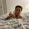 baby, bed, blanket, child, clothing, cozy, crawling, curly_hair, cute, door, furniture, happy, head, indoor, infant, person, skin, smile, soft_texture, young
