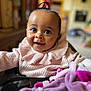 baby, child, smiling, pink_sweater, ruffled_collar, high_chair, indoor, toy, soft_toy, curious, happy, portrait, one_person, young_child, cute, infant, person, close_up, bright_eyes, cozy