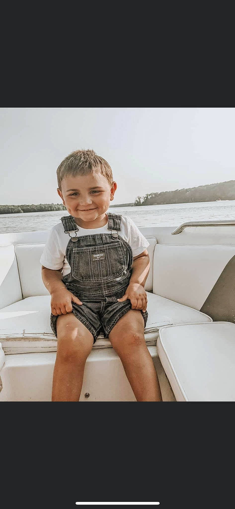 Skyler joined the competition — help win amazing prizes! baby_toddler_clothing, boat, comfort, eyewear, flash_photography, foot, fun, happy, human_leg, joy, leisure, person, recreation, shorts, sitting, sky, sleeve, smile, t_shirt, thigh