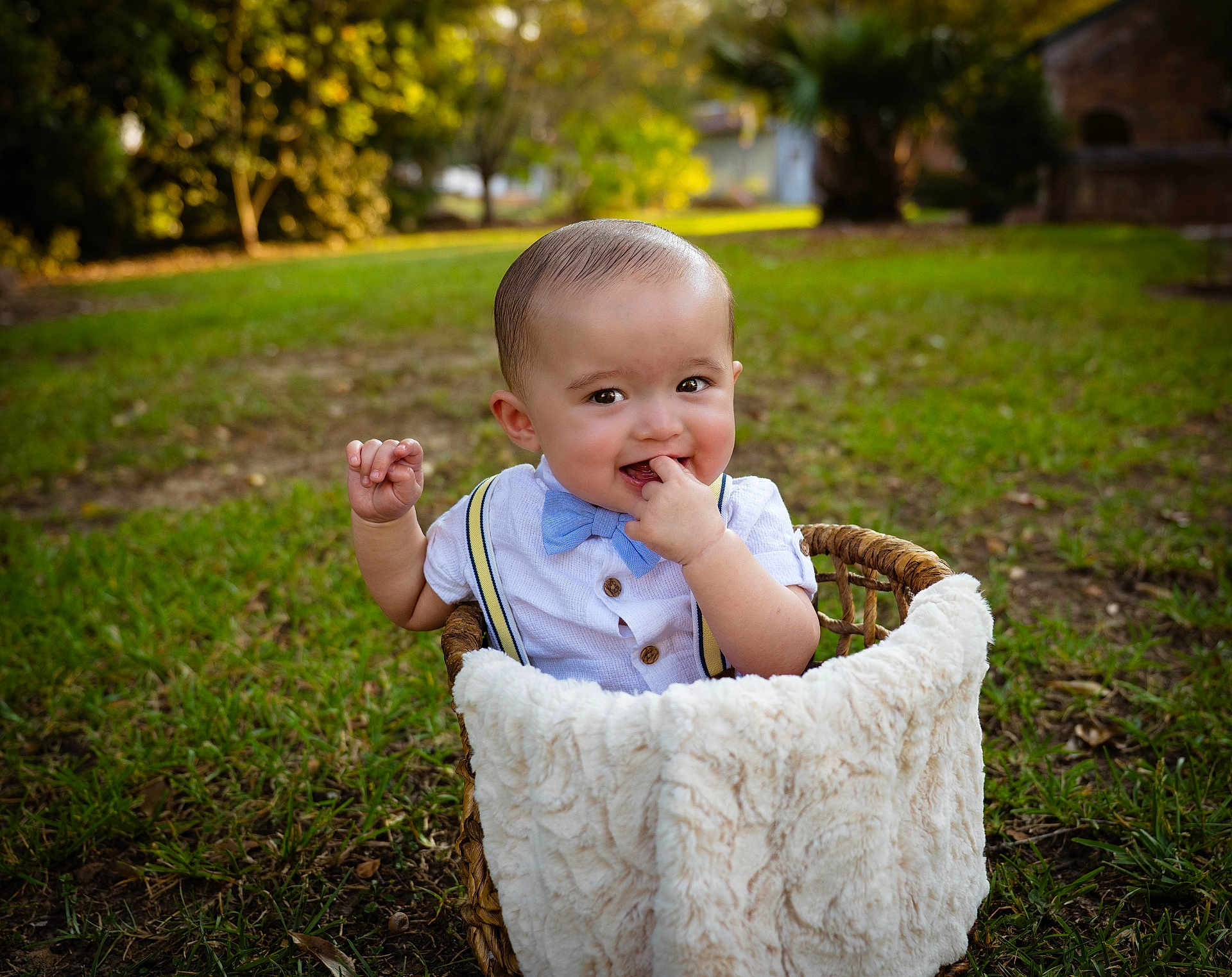 Vinay joined the competition — help win amazing prizes! baby, basket, bow_tie, boy, chewing, child, clothing, cute, face, grass, greenery, hand, happy, infant, nature, outdoor, portrait, smile, sunlight, suspenders