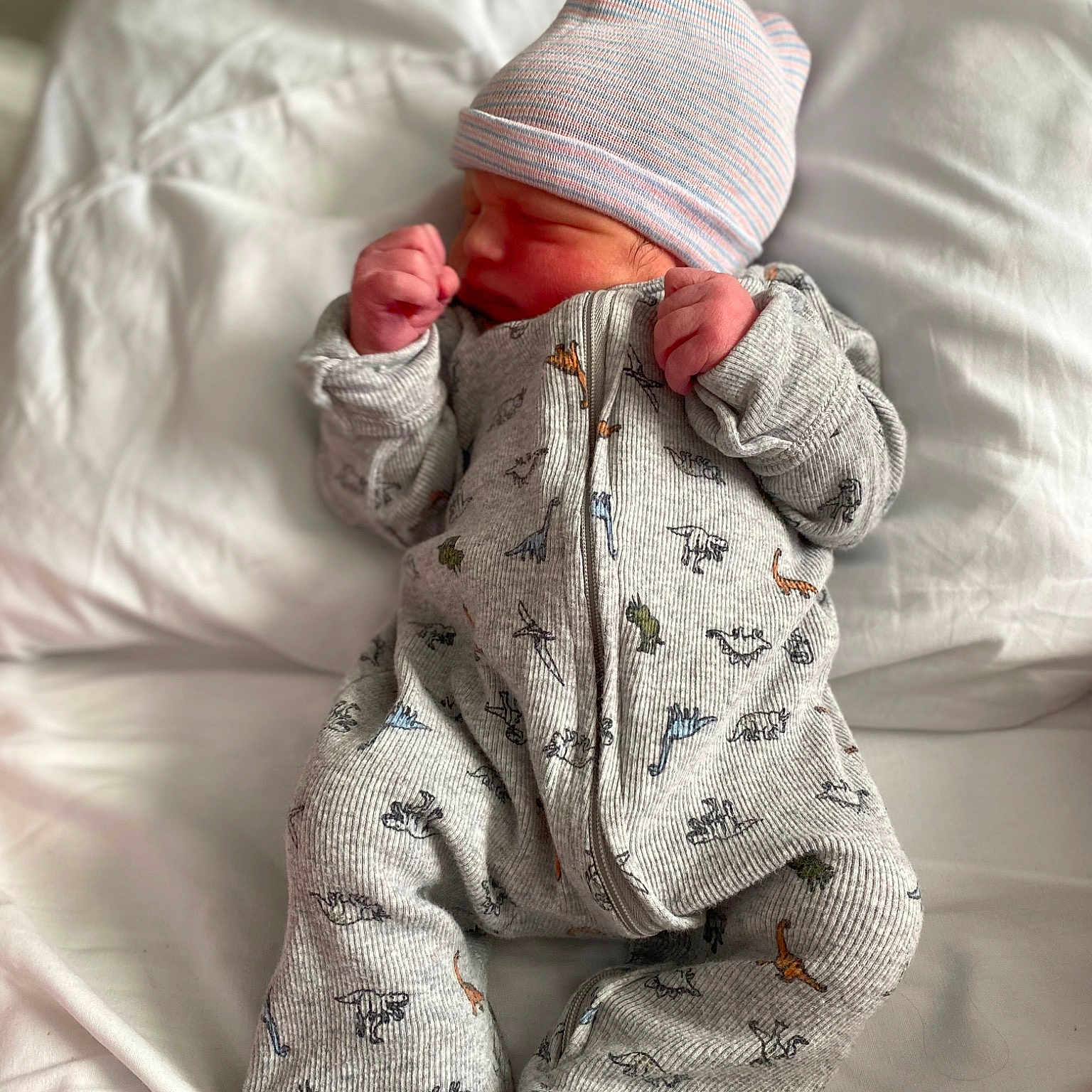 Hunter is registered to the contest to win money with this photo: baby, baby_sleeping, baby_toddler_clothing, beanie, bedding, cap, carmine, child, comfort, flooring, foot, fur, linens, military_camouflage, outerwear, pattern, sitting, sleep, sleeve, toddler