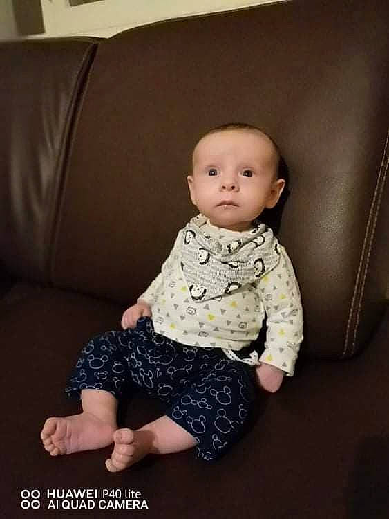 Ayrton a rejoint le concours — aidez-le/la à gagner de superbes lots ! baby, baby_toddler_clothing, cheek, child, comfort, couch, day_dress, flash_photography, flooring, one_piece_garment, pattern, person, portrait_photography, room, sitting, skin, sleeve, t_shirt, toddler, wood