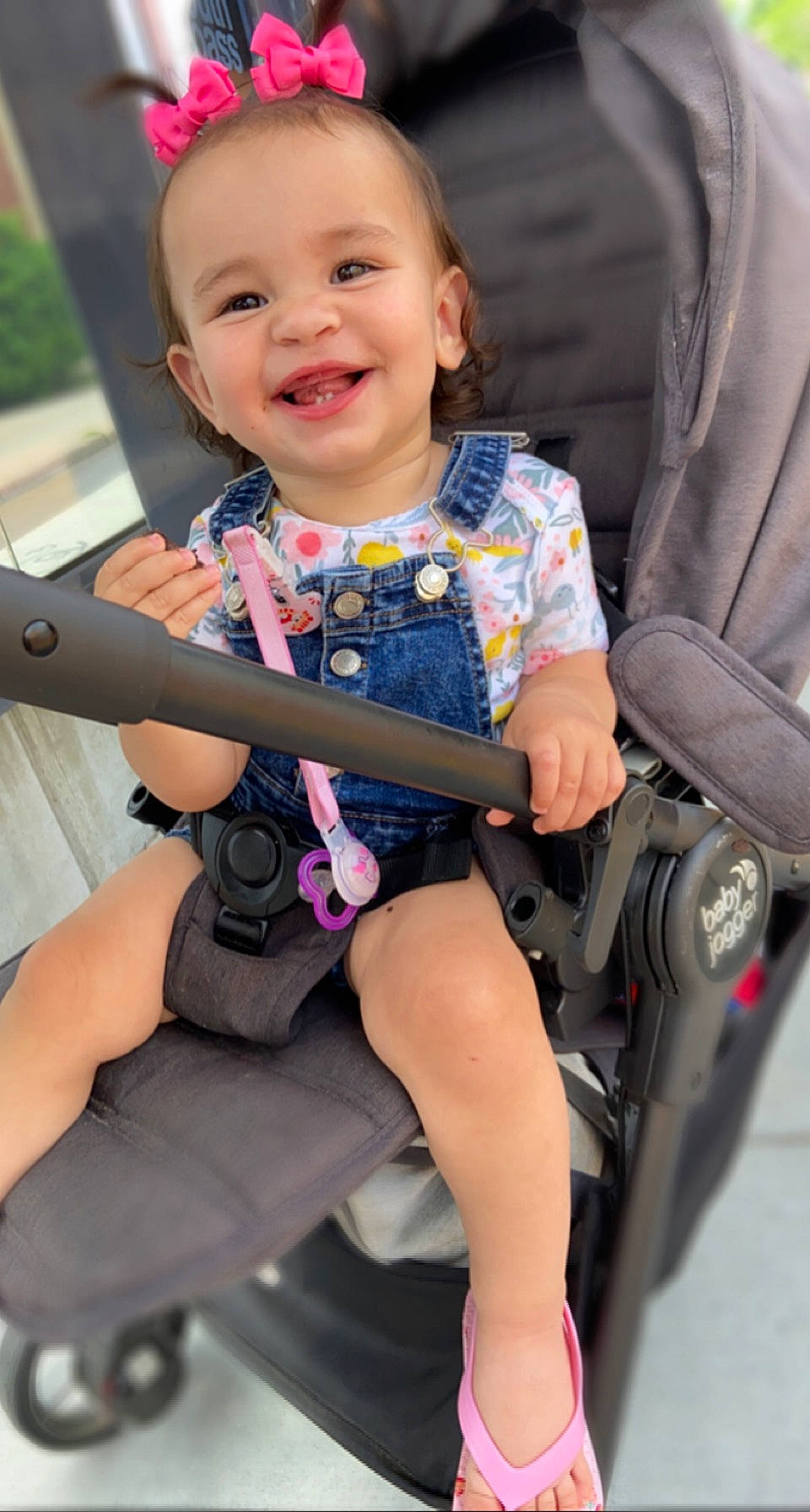 Gabriela joined the competition — help win amazing prizes! baby_carriage, baby_toddler_clothing, chair, dress, eye, face, finger, gesture, hairstyle, happy, head, joy, lap, leg, person, pink, product, skin, smile, tire