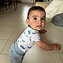 Gabin participe au concours pour gagner de l'argent avec cette photo : toddler, child, baby, indoor, couch, pajamas, whale_pattern, floor, tile, dog, pet, furniture, curious, expression, portrait, hand, face, clothing, home, blanket