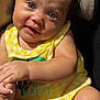 baby, child, curly_hair, blue_eyes, yellow_outfit, sitting, hand_holding, cushion, seat, portrait, indoor, soft_light, cute, infant, smile, skin, person, closeup, young, happy