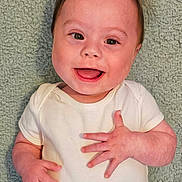Jason joined the competition — help win amazing prizes! baby, smile, infant, child, white_onesie, happy, face, portrait, lying_down, hands, cute, skin, hair, eyes, expression, young, toddler, background, texture, blanket