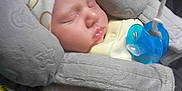 Bradlee is registered to the contest to win money with this photo: baby, car_seat, child, closeup, comfort, cozy, cute, hat, indoors, infant, infant_care, nap, newborn, pacifier, peaceful, resting, seat_belt, sleeping, soft, yellow_clothing