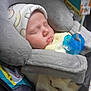 Bradlee is registered to the contest to win money with this photo: baby, sleeping, pacifier, car_seat, hat, infant, cozy, soft, child, cute, yellow_clothing, closeup, indoors, peaceful, resting, newborn, comfort, infant_care, seat_belt, nap
