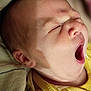 baby, newborn, yawning, face, mouth_open, sleepy, blanket, clothing, striped, soft_texture, skin, infant, cute, closeup, head, ear, nose, expression, human, portrait