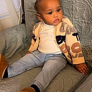 Aaron joined the competition — help win amazing prizes! toddler, child, sitting, armchair, clothing, jeans, cardigan, white_shirt, indoor, portrait, baby, footwear, cozy, furniture, home, cute, expression, young_child, relaxed, seated